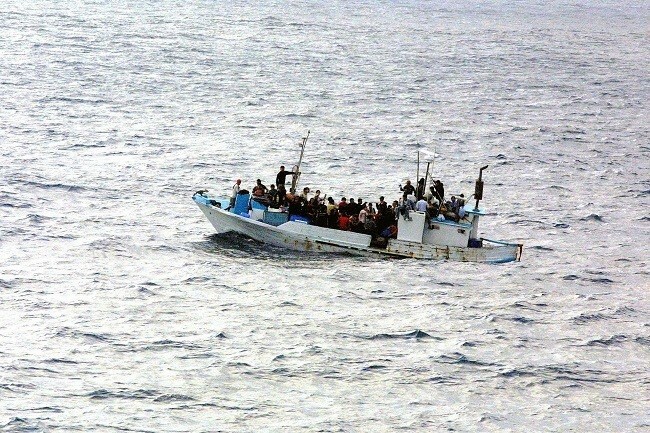 types of migration, forced migration, people migrating on a boat