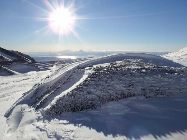 landscape of a mountain with snow with the sun