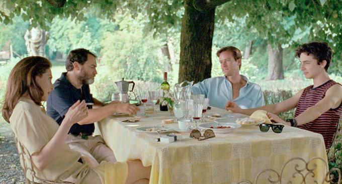 Oliver and Elio at table with family.
